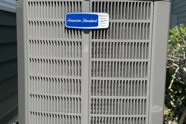 An American Standard condensing unit installed on a pad