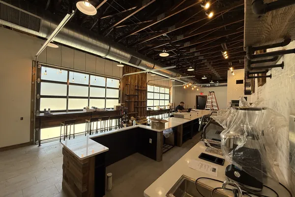 Ductwork and lighting above a finished cafe counter