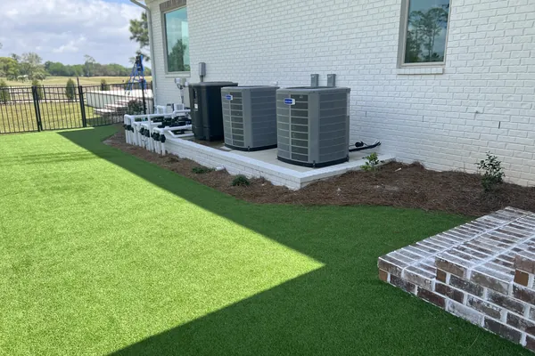 Condensing units installed beside a newly built home