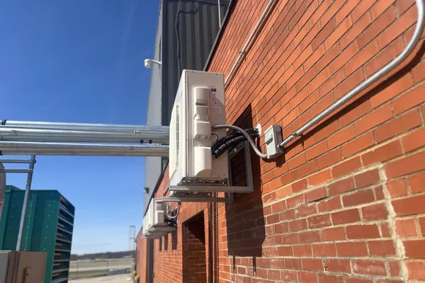 Ductless condensers mounted on a brick exterior wall