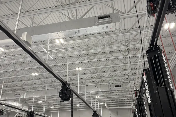 Exposed ceiling ductwork and lighting in a fitness facility