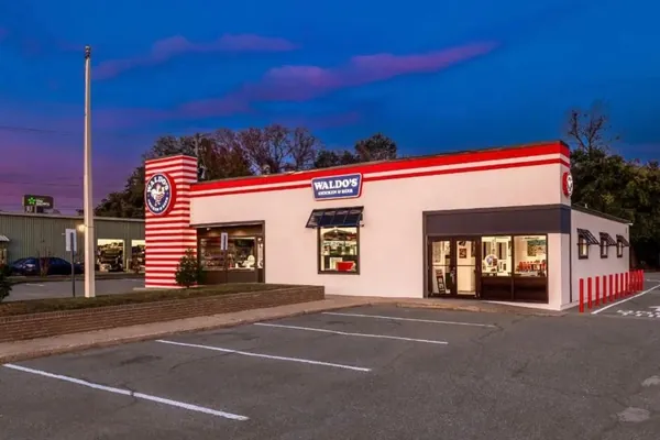 Exterior of a completed restaurant project at dusk