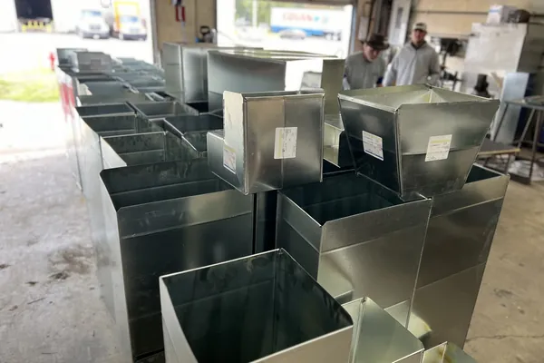 Custom sheet metal fittings laid out in the fabrication shop