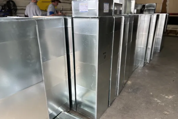 Fabricated sheet metal ductwork stacked and ready for install