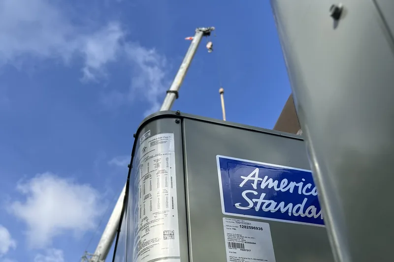 Commercial HVAC work by Climatech of Professional Air &mdash; an American Standard rooftop unit rigged to a crane