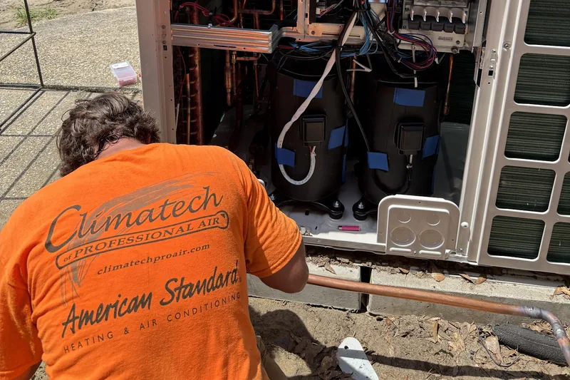 Commercial HVAC work by Climatech of Professional Air &mdash; a Climatech technician working inside an open Samsung outdoor unit