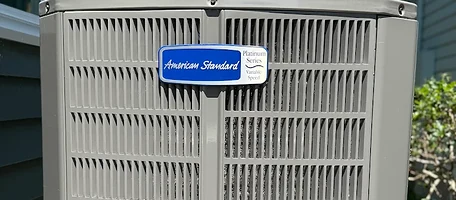 Close-up of an American Standard Platinum Series variable-speed condenser coil and badge