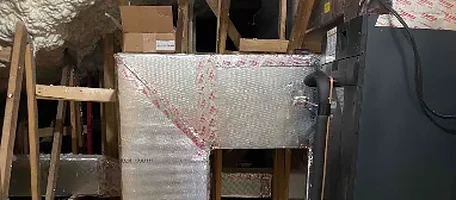 Insulated supply plenum and ductwork connected to a furnace in an attic